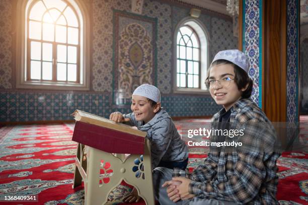 happy muslim young kid read quran together in mosque. - turkey school stockfoto's en -beelden