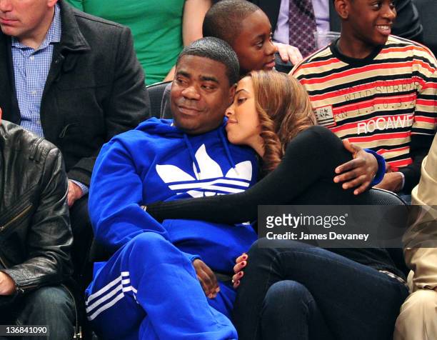Tracy Morgan and Megan Wollover attend the Philadelphia 76ers vs the New York Knicks game at Madison Square Garden on January 11, 2012 in New York...