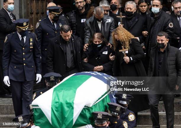 Family members of slain NYPD Officer Wilbert Mora follow the casket outside St. Patrick's Cathedral in Manhattan on February 2 in New York CIty. Mora...