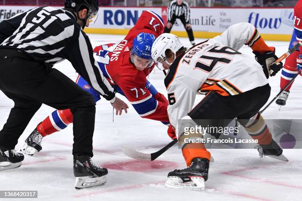 Jake Evans of the Montreal Canadiens faces off against Trevor Zegras of the Anaheim Ducks in the NHL game at the Bell Centre on January 27, 2022 in...