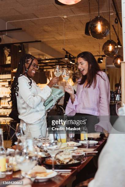 cheerful female friends toasting drinks at bar - the brunch stock pictures, royalty-free photos & images
