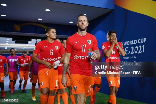 Sylvain Graglia of AS Pirae leads his team out for the warm up prior to the FIFA Club World Cup UAE 2021 1st Round match between Al Jazira Club and...