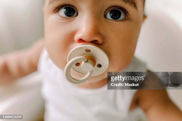 male toddler with pacifier at home - pacifier stock pictures, royalty-free photos & images