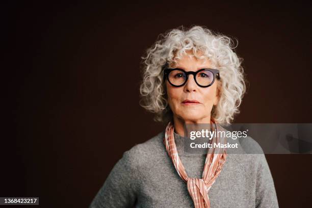 portrait of confident elderly woman in studio - 65 69 anos imagens e fotografias de stock