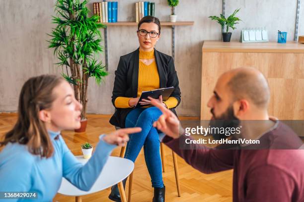 couple arguing during therapy session - married doctors stock pictures, royalty-free photos & images