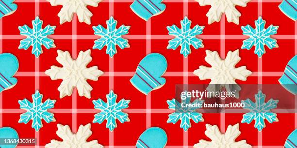 mitten, blue and white snowflakes: christmas cookie repeating pattern background wallpaper - cookie decorating stock illustrations