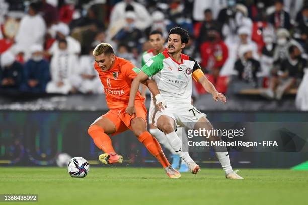Tehotu Gitton of AS Pirae battles for possession with Ahmed Al Hashmi of Al Jazira Club during the FIFA Club World Cup UAE 2021 1st Round match...