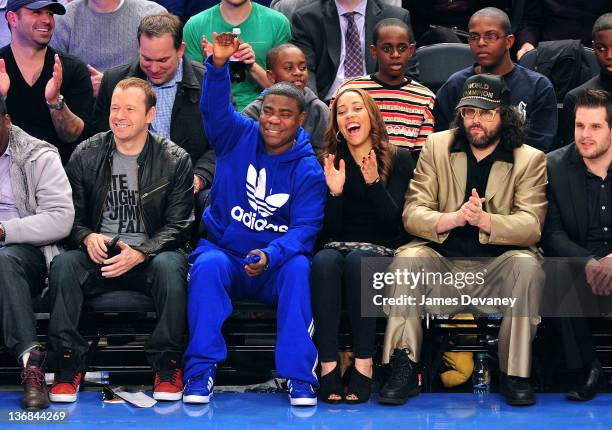 Donnie Wahlberg, Tracy Morgan, Megan Wollover and Judah Friedlander attend the Philadelphia 76ers vs the New York Knicks game at Madison Square...