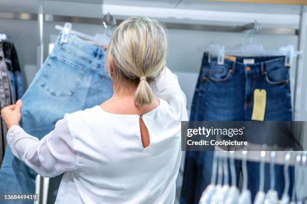 woman in a shopping center - woman in jeans from behind stock pictures, royalty-free photos & images
