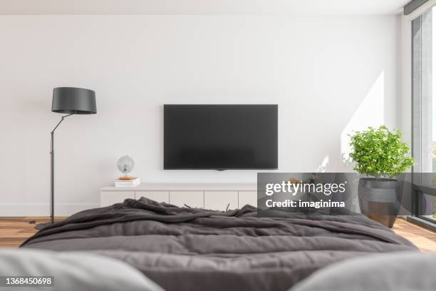 pov modern bedroom with television - wall of tvs stock pictures, royalty-free photos & images