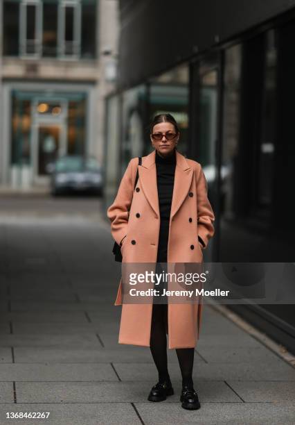 Aline Kaplan wearing Carolina Lemke shades, beige EN OR coat, Filippa K turtleneck, a black Mango skirt, a black Boyy Botique bag and Zara loafer on...
