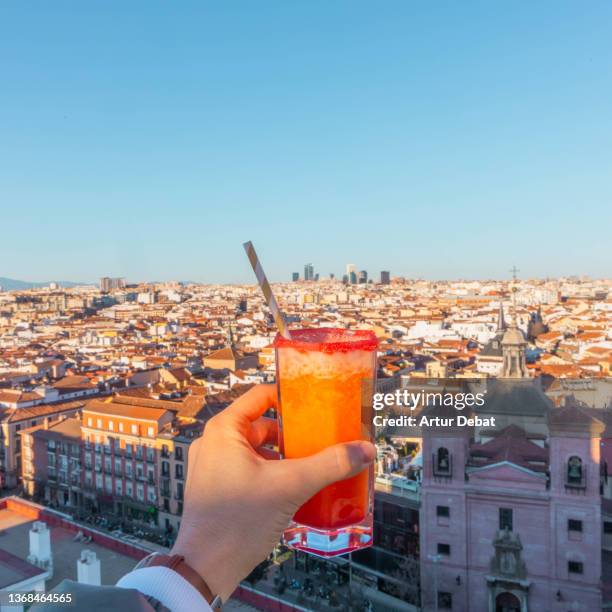 drinking cocktail in skybar with the views of madrid city. - paseo de la castellana madrid fotografías e imágenes de stock