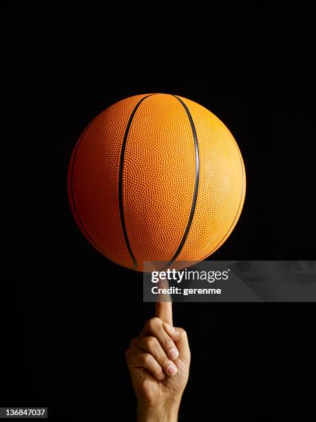man spinning basketball in air - basketball spin finger stock pictures, royalty-free photos & images