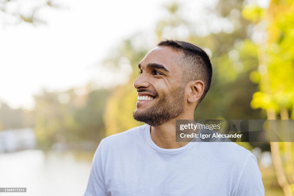 Young smiling athlete in public park