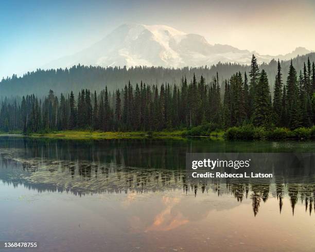 a smoky view of the mountain at reflection lakes - calm water stock pictures, royalty-free photos & images