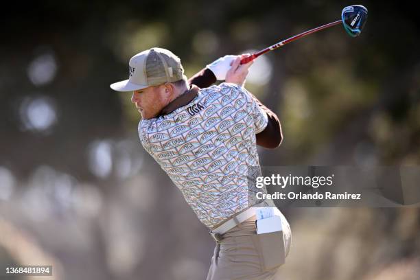 Boxer Canelo Alvarez plays his shot from the fifth tee during the first round of the AT&T Pebble Beach Pro-Am at Monterey Peninsula Country Club on...