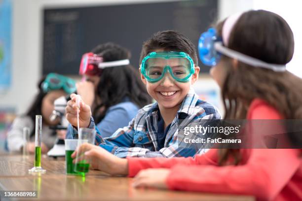 working together in science class - science kids beaker stock pictures, royalty-free photos & images