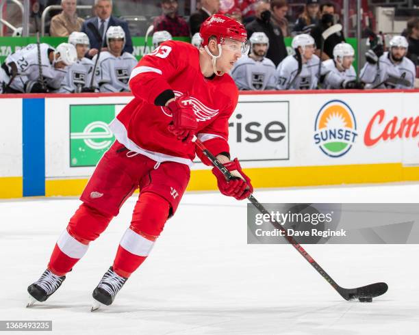 Adam Erne of the Detroit Red Wings turns up ice with the puck against the Los Angeles Kings during the second period of an NHL game at Little Caesars...