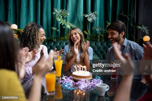gruppo di amici che cantano buon compleanno a una donna in un ristorante - colombia party foto e immagini stock