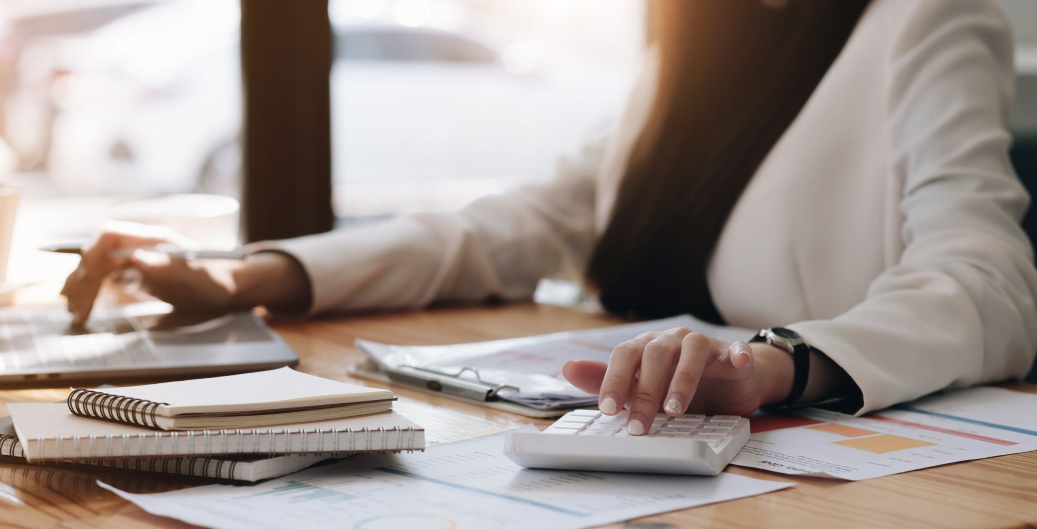 Close up Businessman using calculator and laptop for calaulating finance, tax, accounting, statistics and analytic research concept Close up Businessman using calculator and laptop for calaulating finance, tax, accounting, statistics and analytic research concept