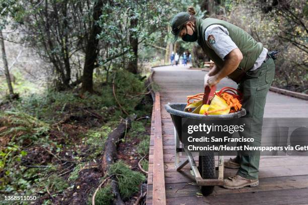 Trail crew member Rudy Gustafson works to put up the iconic Muir Woods sign following repairs to the boardwalk at Muir Woods National Monument in...