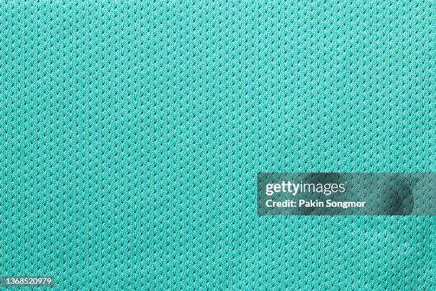 fabric for sports clothing in a green color, the texture of a football shirt jersey, and a textile background - mesh textile foto e immagini stock