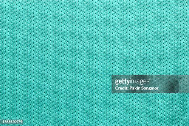 fabric for sports clothing in a green color, the texture of a football shirt jersey, and a textile background - football jersey stock pictures, royalty-free photos & images