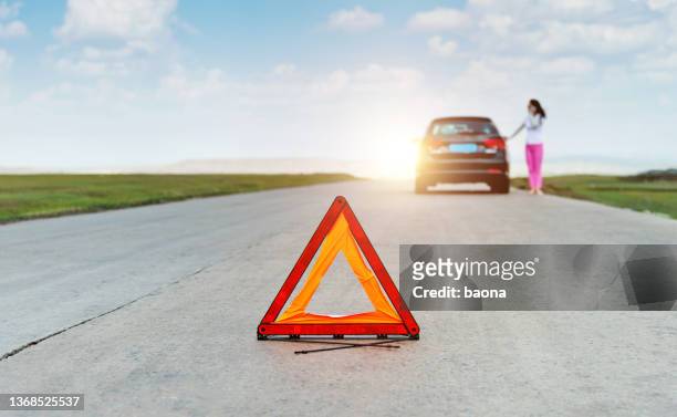 red triangle sign behind the broken car - roadside assistance stock pictures, royalty-free photos & images