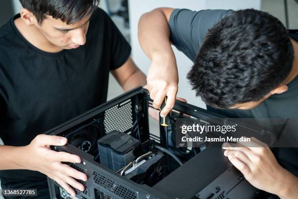 young teenage students working on computer - computer repair stock pictures, royalty-free photos & images