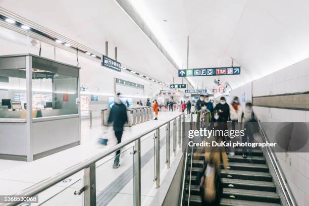 commuters wearing masks in the subway - morning commute stock pictures, royalty-free photos & images