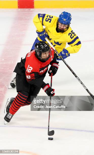 Chiho Osawa of Japan, Lina Ljungblom of Sweden during the Women's Ice Hockey Preliminary Round Group B match between Sweden and Japan at Wukesong...