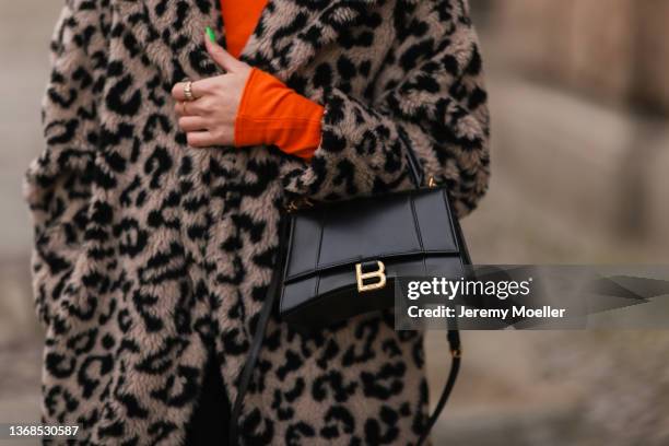 Sonia Lyson wearing Max Mara animal print teddy coat, Balenciaga Hour Glass black leather bag and orange Zara top on February 02, 2022 in Berlin,...