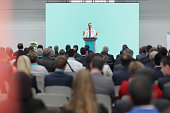 Male doctor giving a speech on a podium at a conference