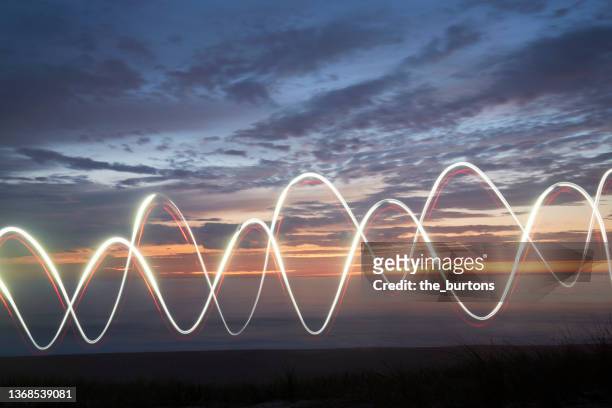 light painting at the sea during sunset - twilight market stock pictures, royalty-free photos & images