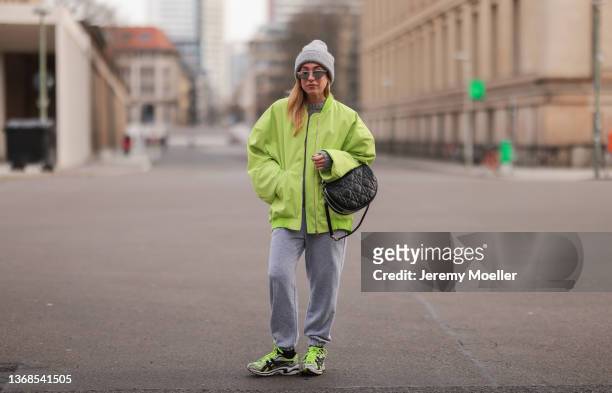 Sonia Lyson wearing New balance black and green sneaker, Zara grey hat, H&M grey knit sweater, Lumina green jacket and Lumina grey jogging pants,...