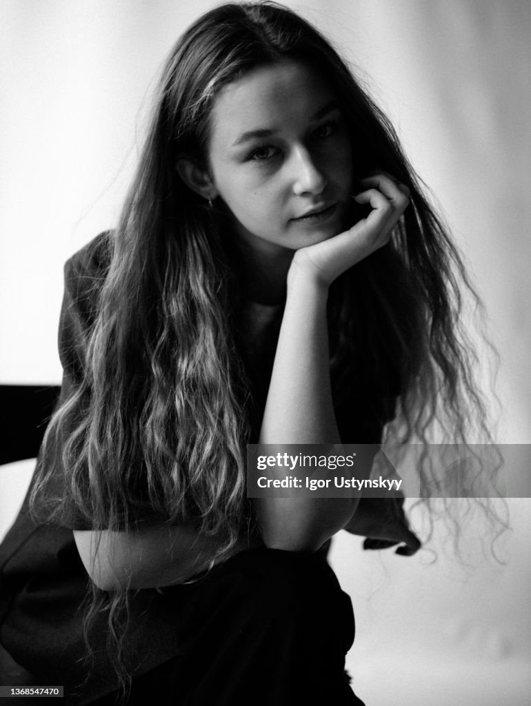 Young beautiful woman sitting on chair