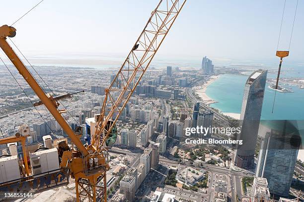 Crane operates above a Central Market residential tower, an Aldar PJSC project, under construction in Abu Dhabi, United Arab Emirates, on Wednesday,...