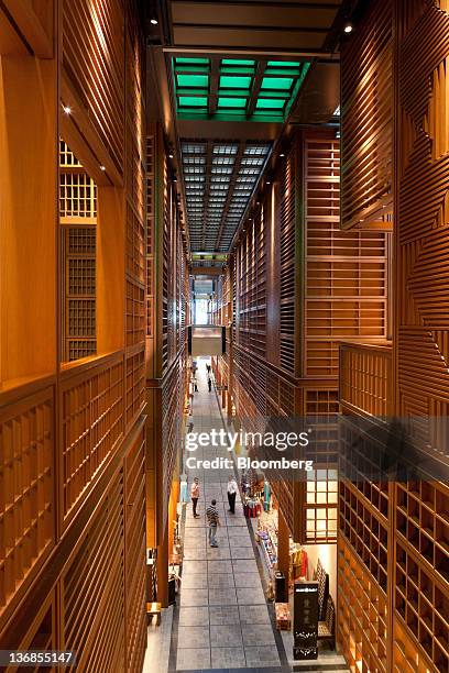 Visitors are seen from above on a store-lined walkway in the Central Market souk, an Aldar PJSC project designed by architects Foster and Partners...