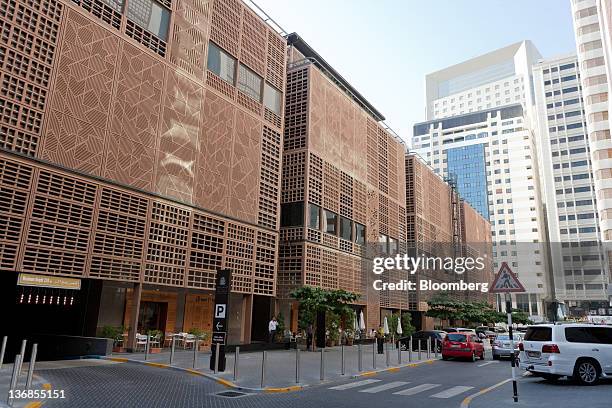 The exterior of the Central Market souk building, left, an Aldar PJSC project designed by architects Foster and Partners Ltd., is seen in Abu Dhabi,...