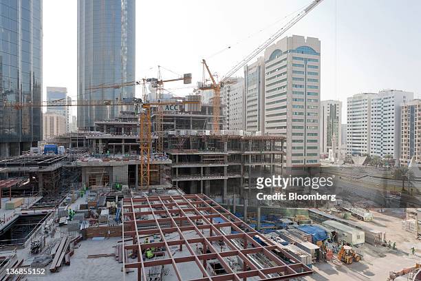 Workers are seen at the site of the Emporium construction, an Aldar PJSC project, in Abu Dhabi, United Arab Emirates, on Wednesday, Jan. 11, 2012....