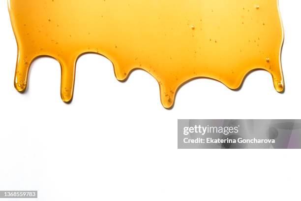 drops of sweet yellow honey on a white isolated background - pegajoso imagens e fotografias de stock