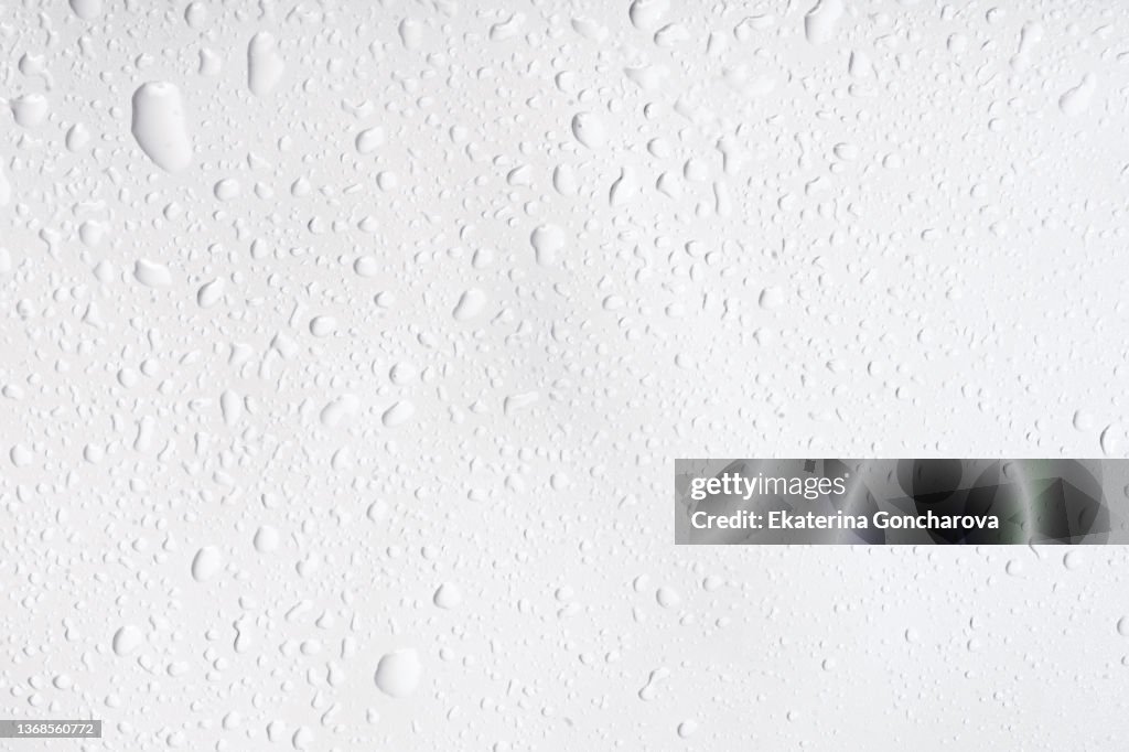 Abstract natural background of drops and splashes of water on a white background