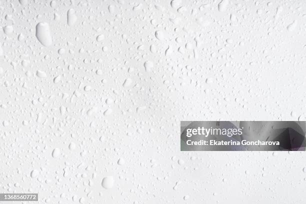 abstract natural background of drops and splashes of water on a white background - blue condensation stock pictures, royalty-free photos & images