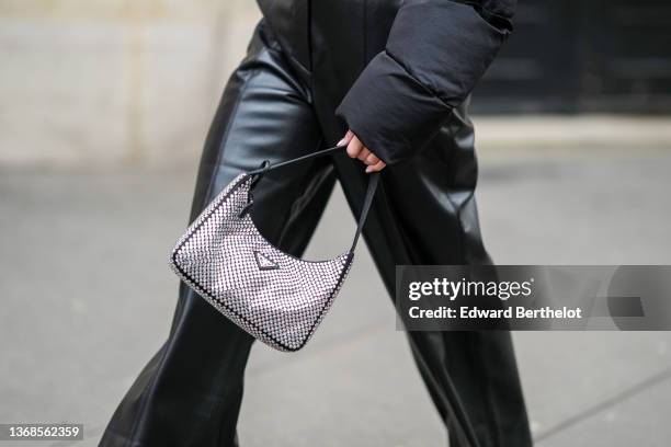 Miki Cheung wears a black cropped t-shirt, a black cropped puffer jacket from Jacquemus, high waist black shiny leather large wide legs pants from...