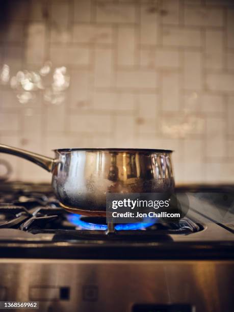 a gas ring burns on a home stove - cooking pan close up stock pictures, royalty-free photos & images