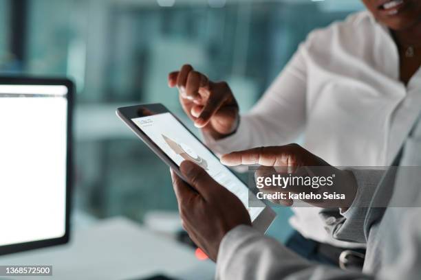 shot of two unrecognizable businesspeople using a digital tablet together at work - screen closeup stock pictures, royalty-free photos & images