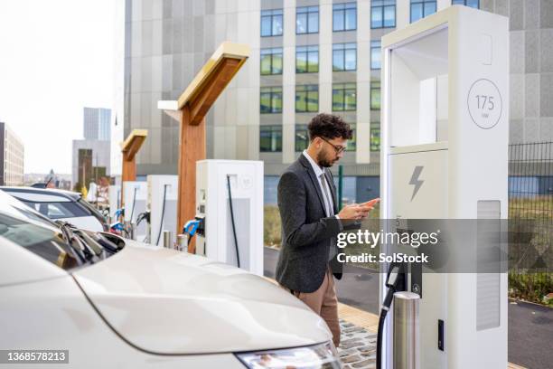 using phone to charge electric car - electrical conductor stock pictures, royalty-free photos & images