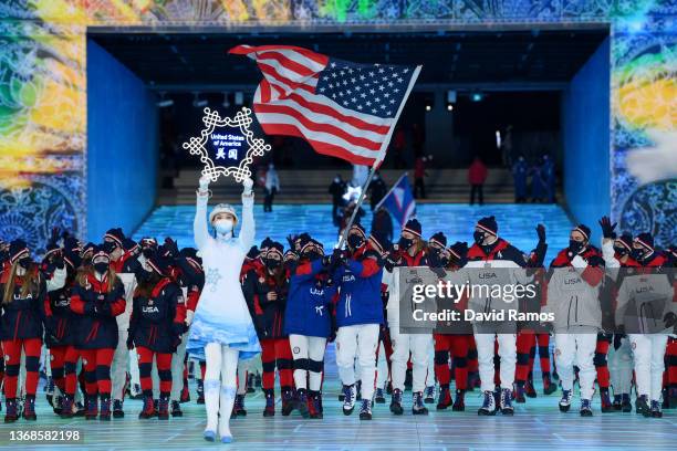 Flag bearers Brittany Bowe and John Shuster of Team United States carry their flag during the Opening Ceremony of the Beijing 2022 Winter Olympics at...