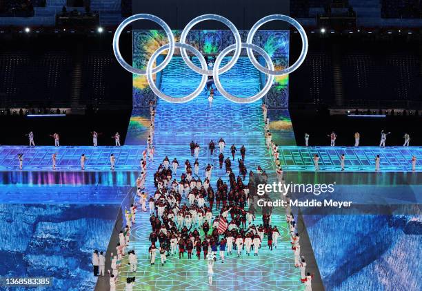 Flag bearers Brittany Bowe and John Shuster of Team United States carry their flag during the Opening Ceremony of the Beijing 2022 Winter Olympics at...