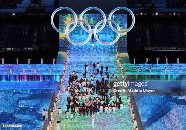 Flag bearers Brittany Bowe and John Shuster of Team United States carry their flag during the Opening Ceremony of the Beijing 2022 Winter Olympics at...